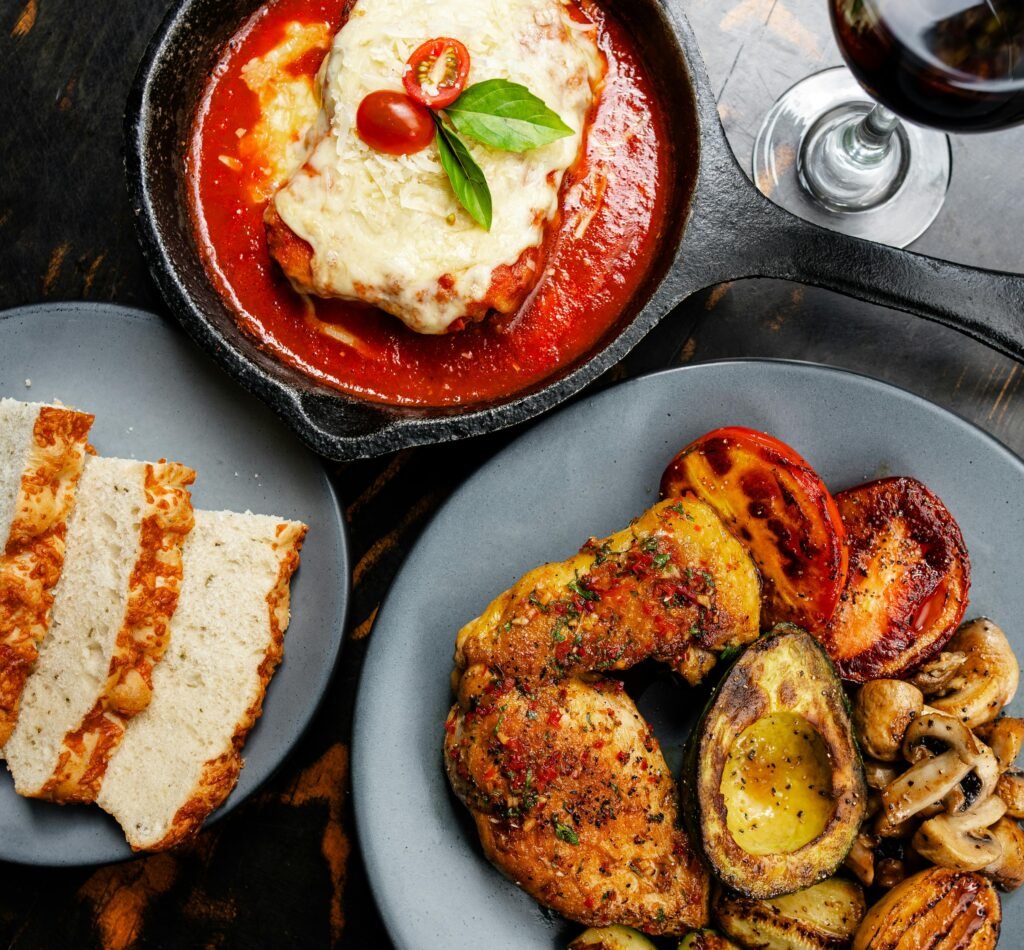 Roasted Meat and Dish with Tomato Sauce on the Table