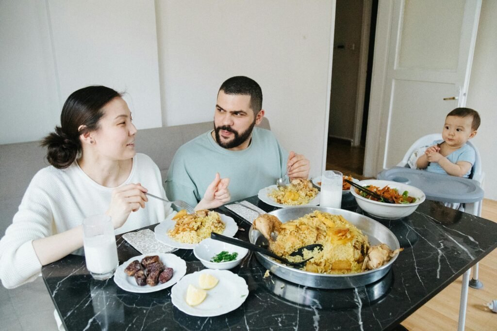 Family with a Little Baby Boy Eating Dinner at Home